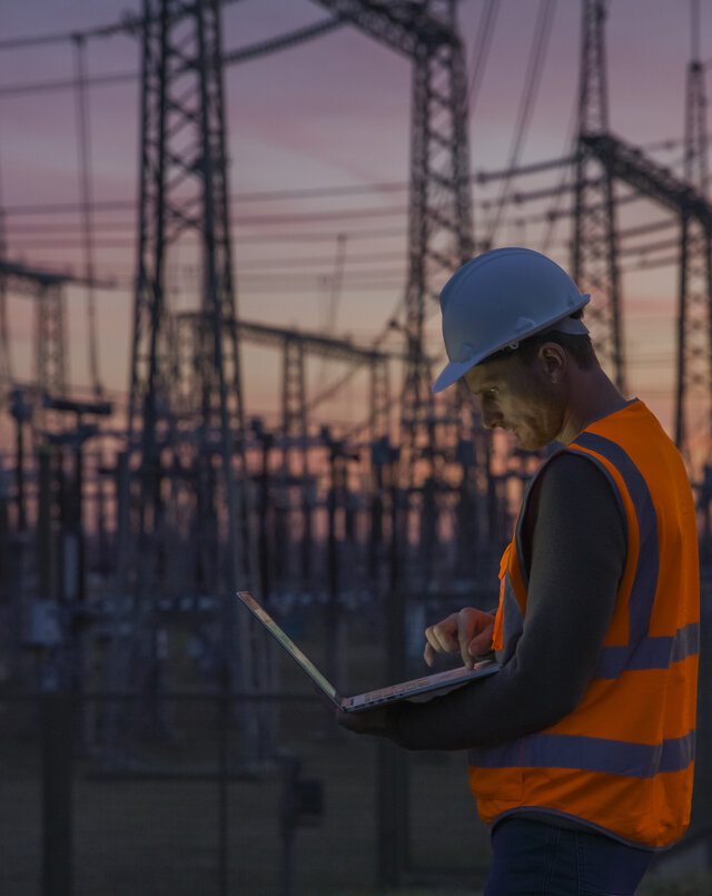 engineer at a substation during sunset
