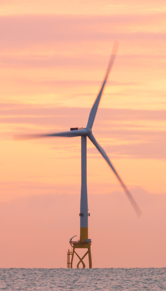 offshore wind turbine at sunset 