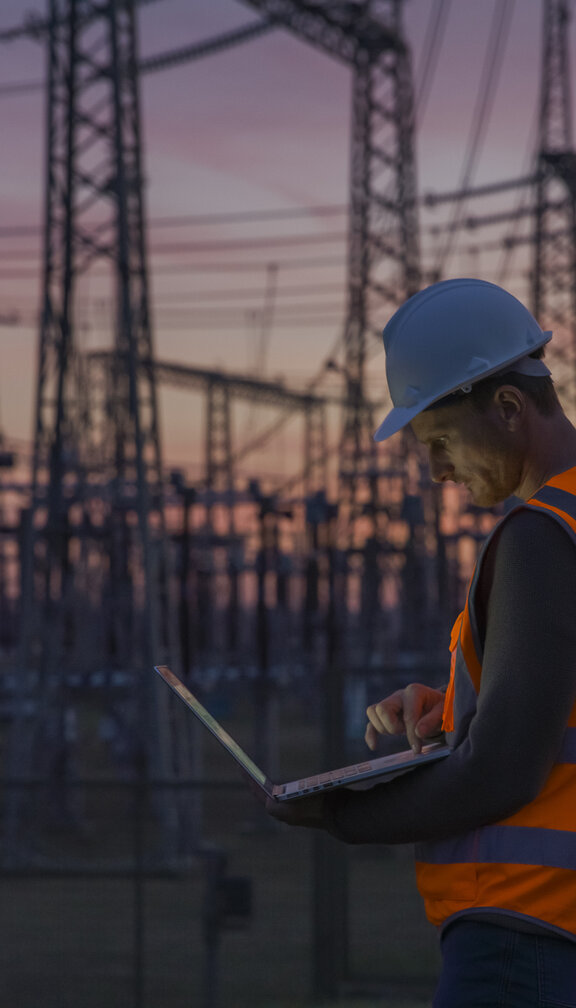 engineer at a substation during sunset