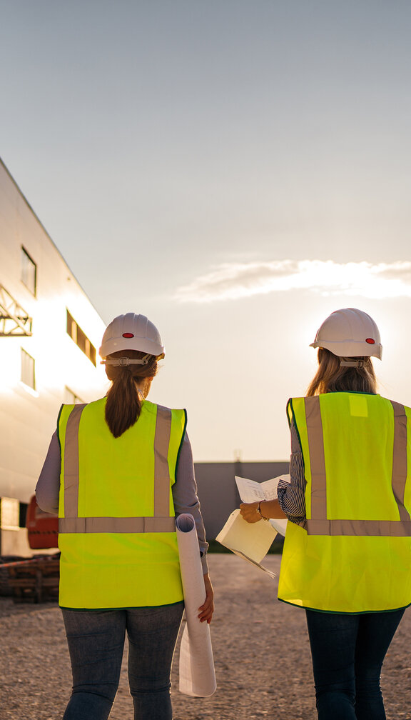 two engineers walking in the sunset