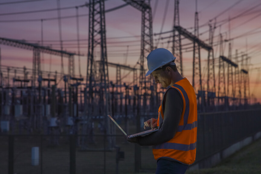 engineer at a substation during sunset