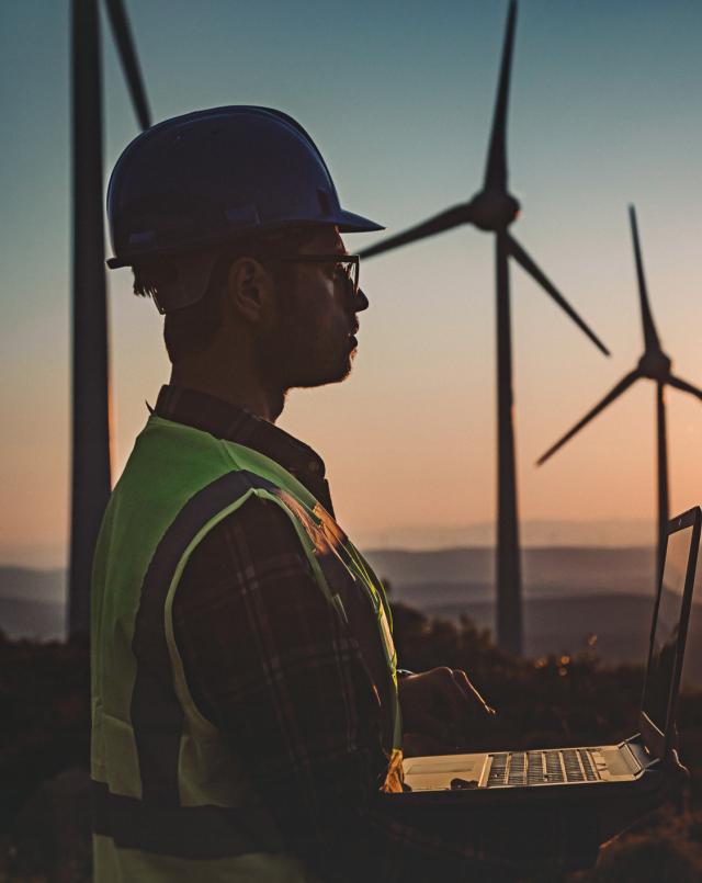 engineer looking at wind turbines