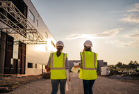 two engineers walking in the sunset