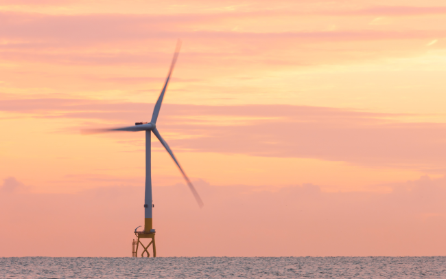 offshore wind turbine at sunset 