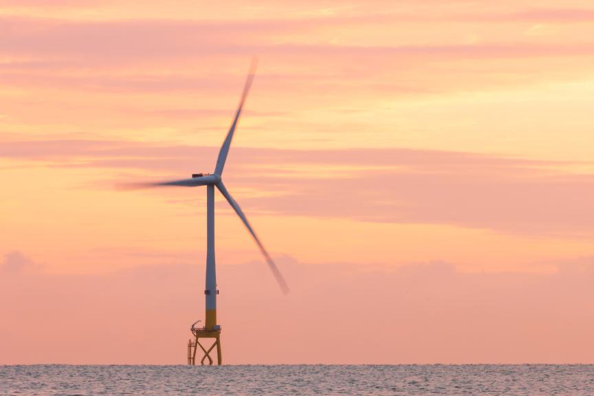 offshore wind turbine at sunset 