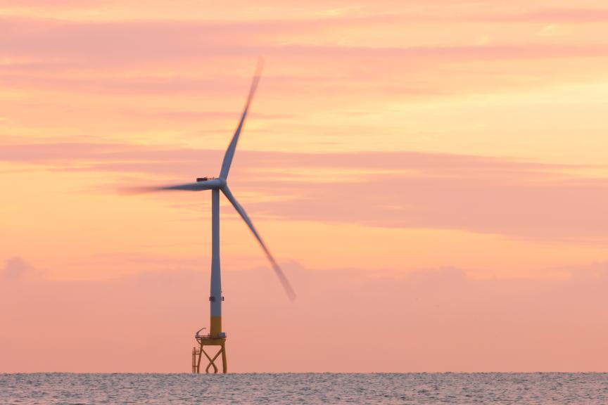 offshore wind turbine at sunset 
